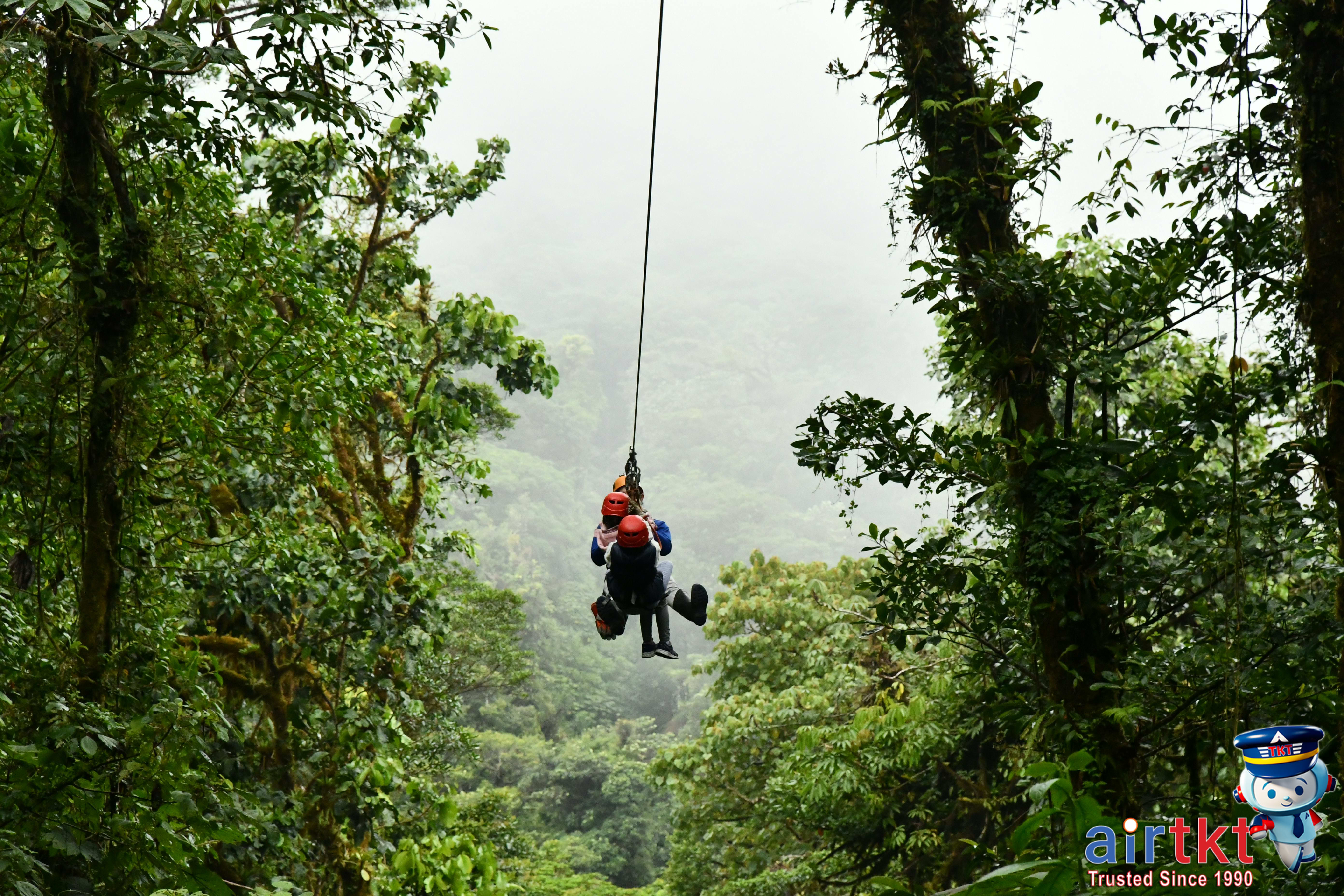 Adventurers zip-lining over Costa Rica’s rainforest canopy