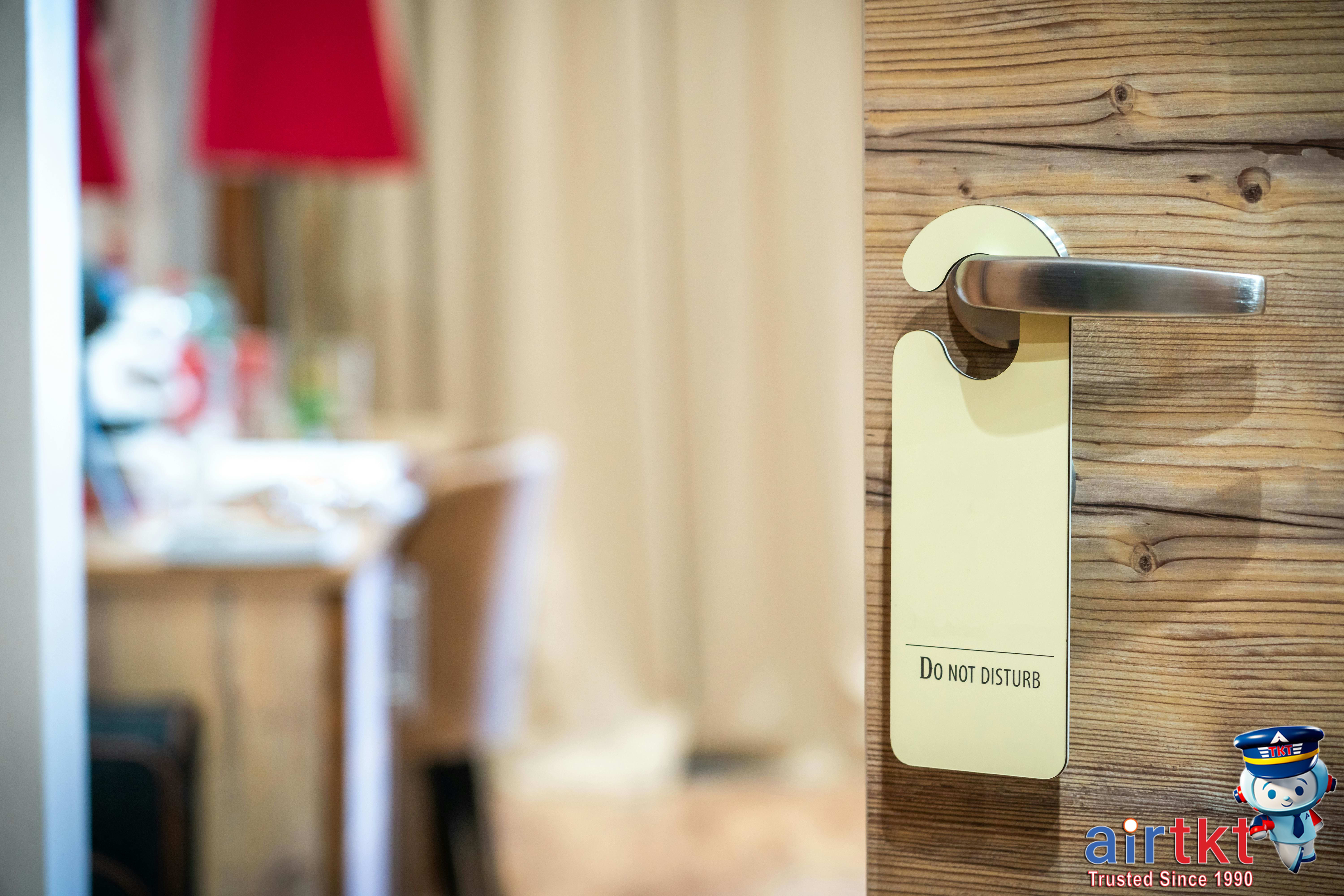 Traveler reviewing hotel cancellation policies on a smartphone