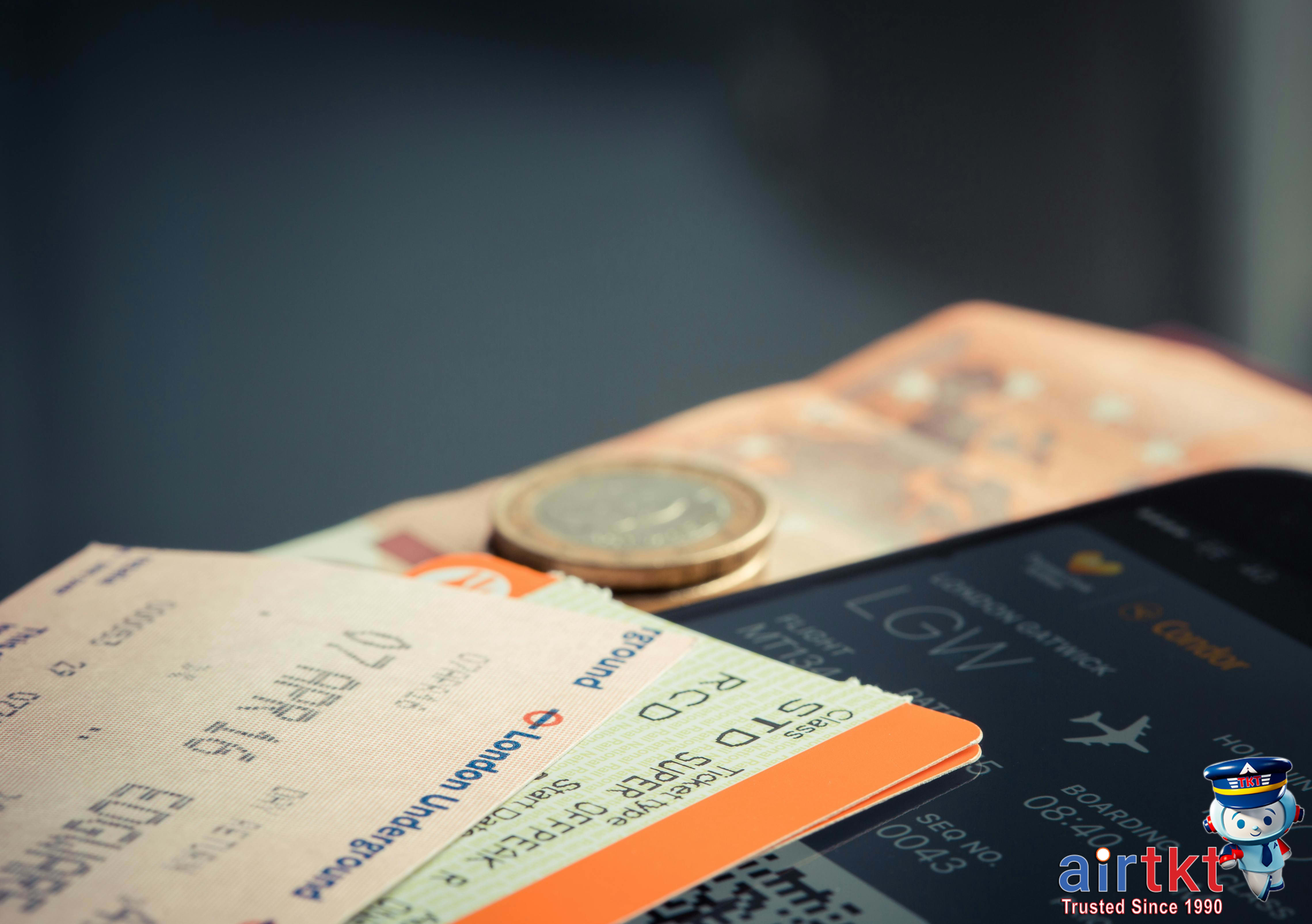 Traveler planning multi-city flights using a map and laptop