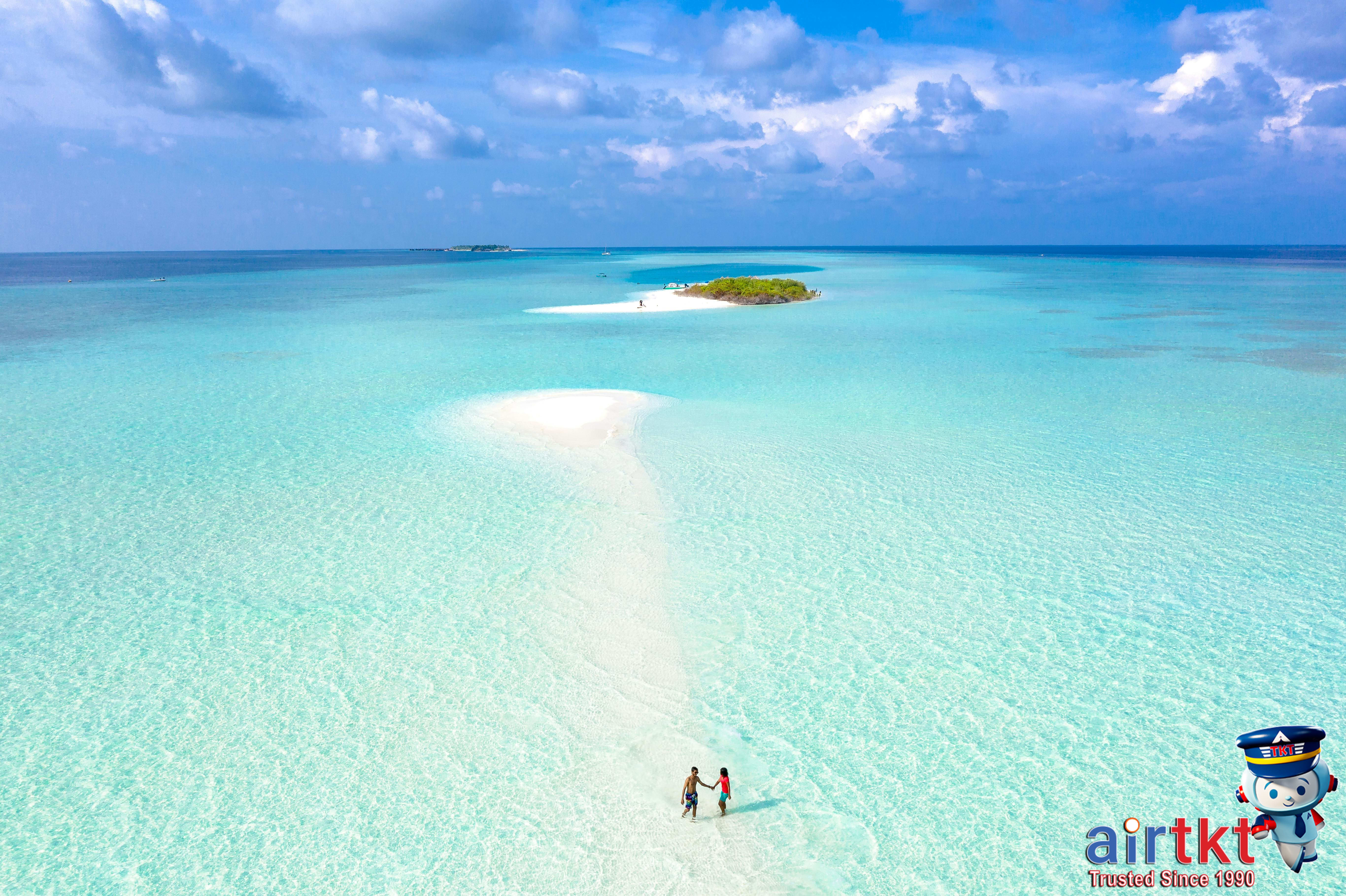 Couple enjoying a scenic Christmas getaway on a tropical beach