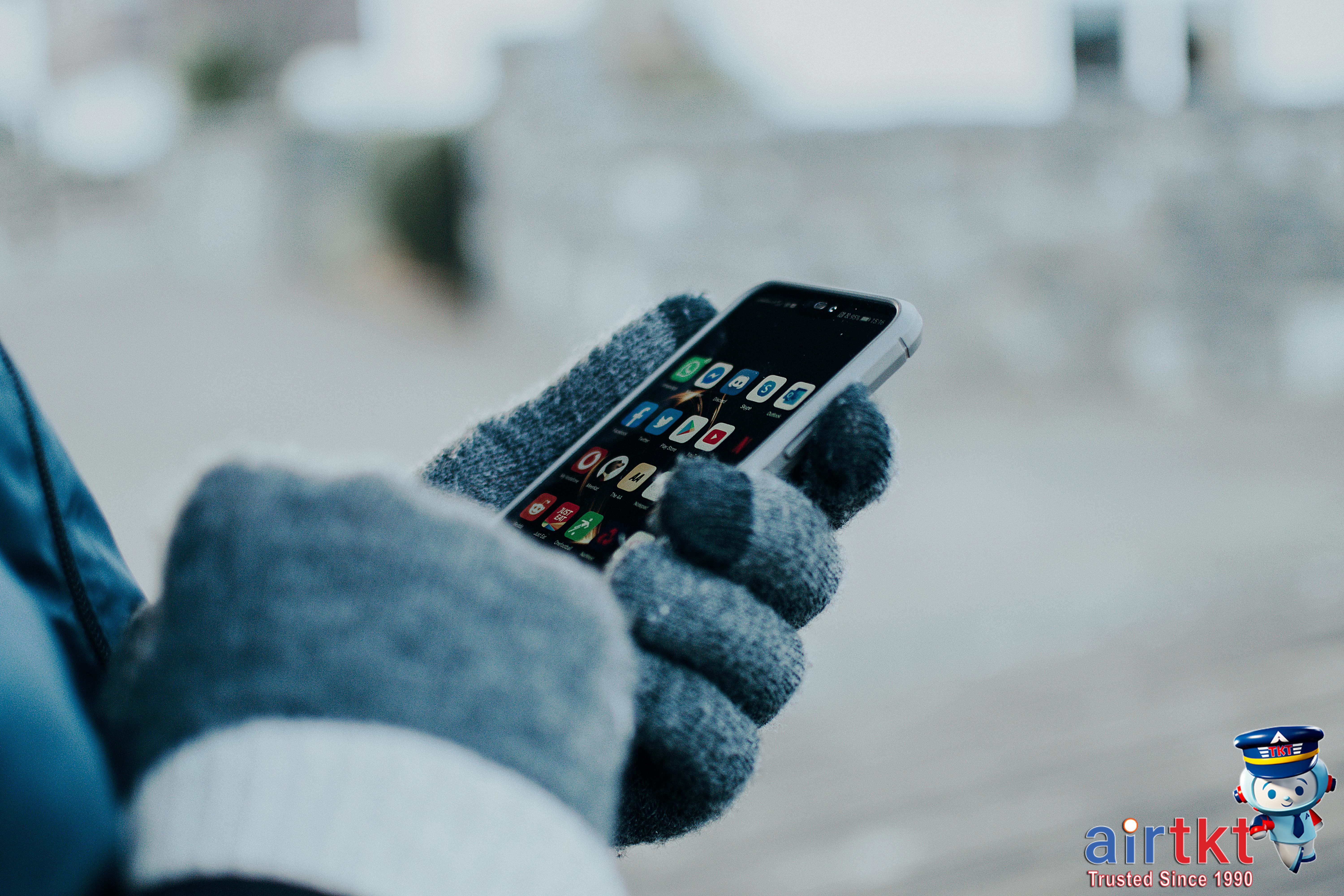 Person using smartphone to check travel deals on social media