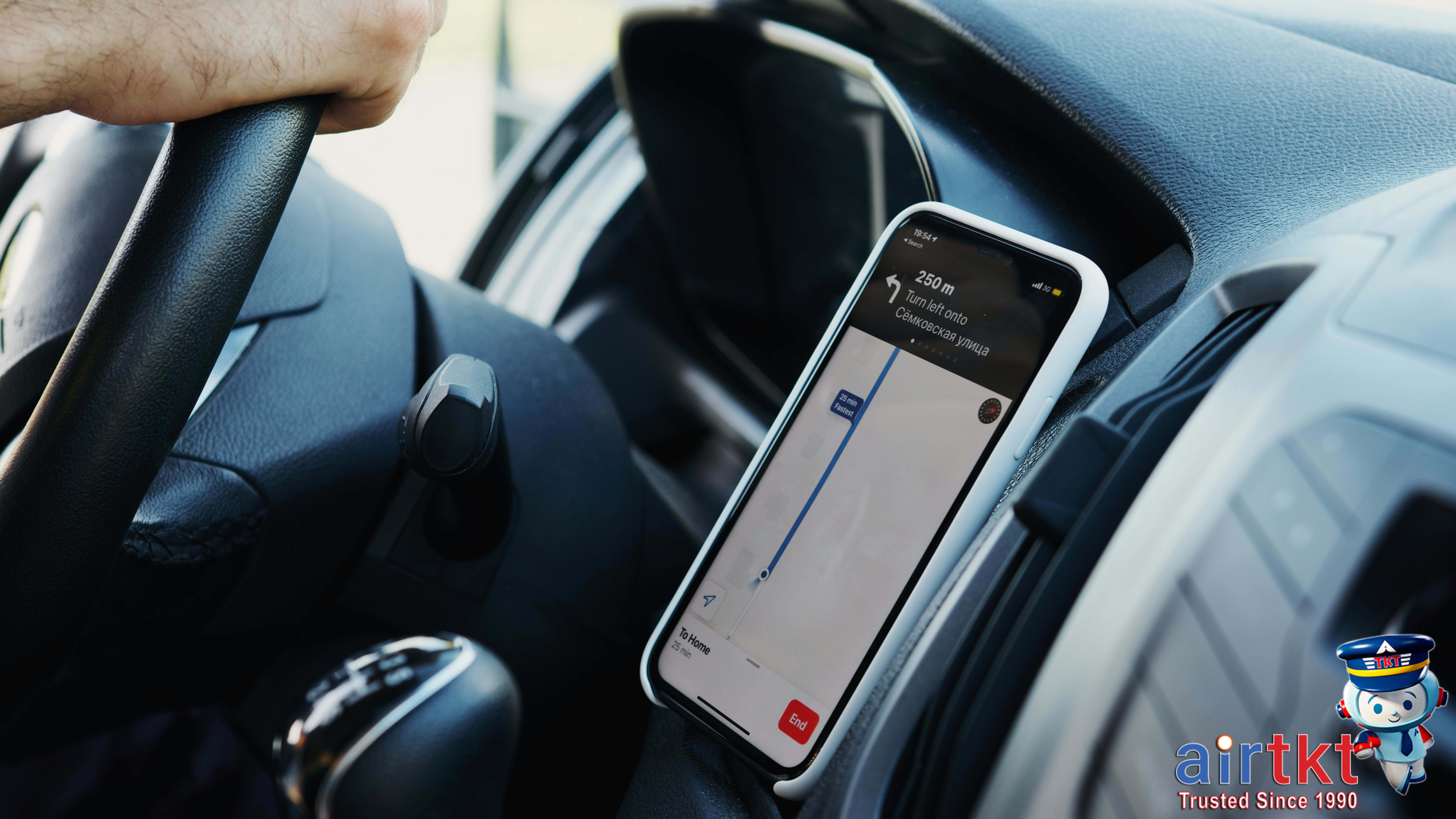 Smartphone displaying transportation apps for road trip savings