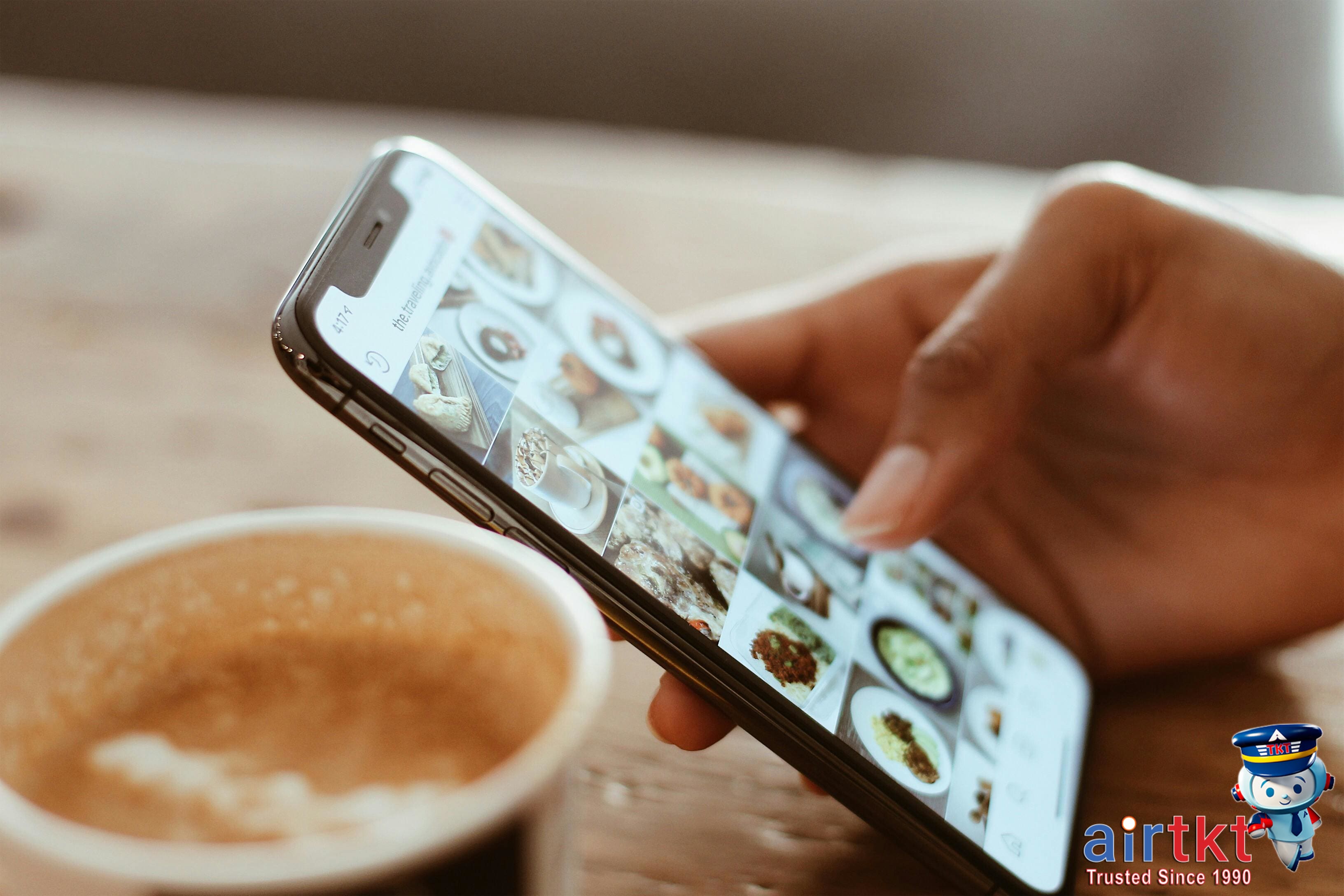 Person using mobile app to track travel budget