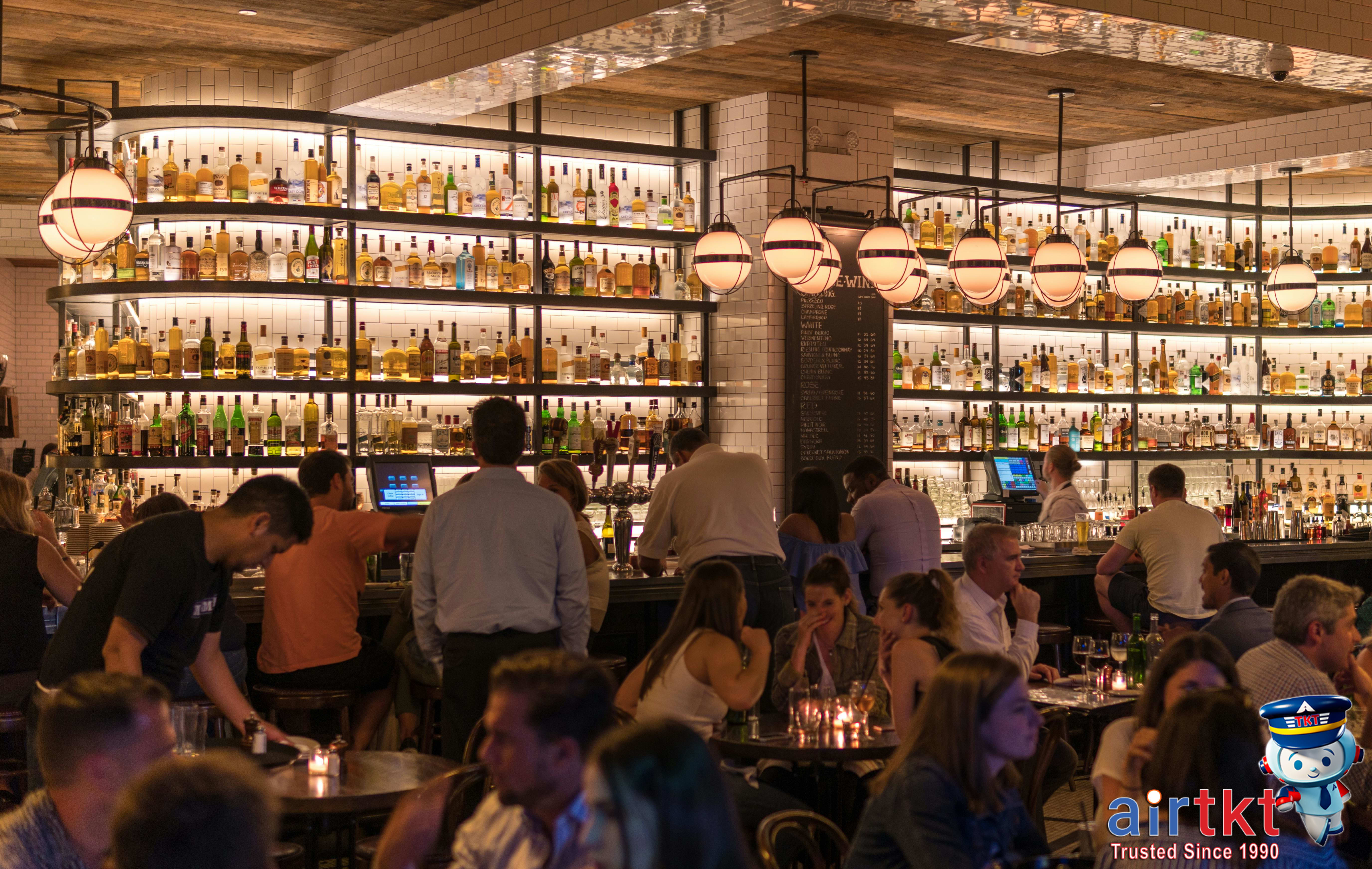 Person holding birthday cake during travel celebration