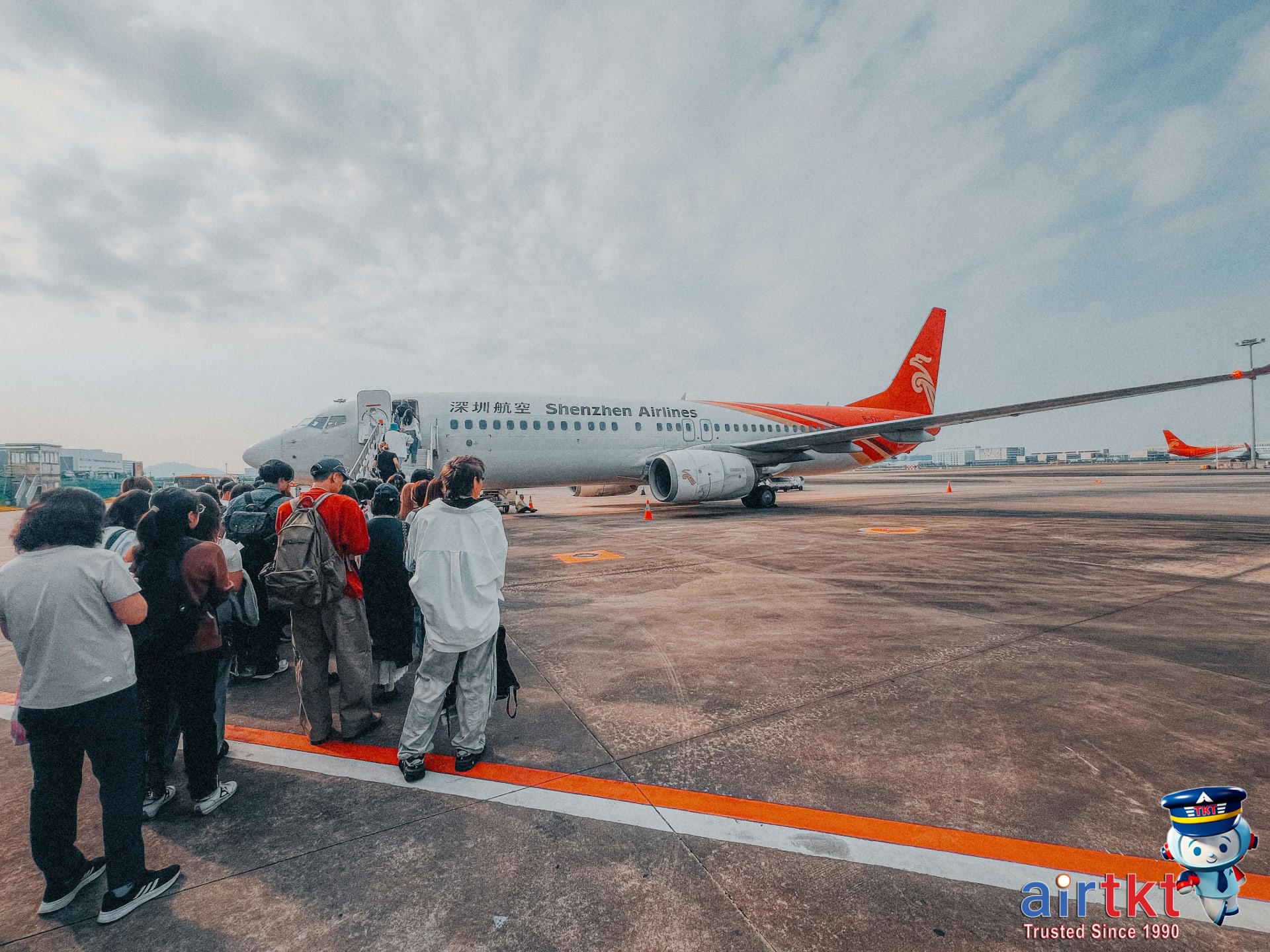 Passengers boarding an airplane at the gate