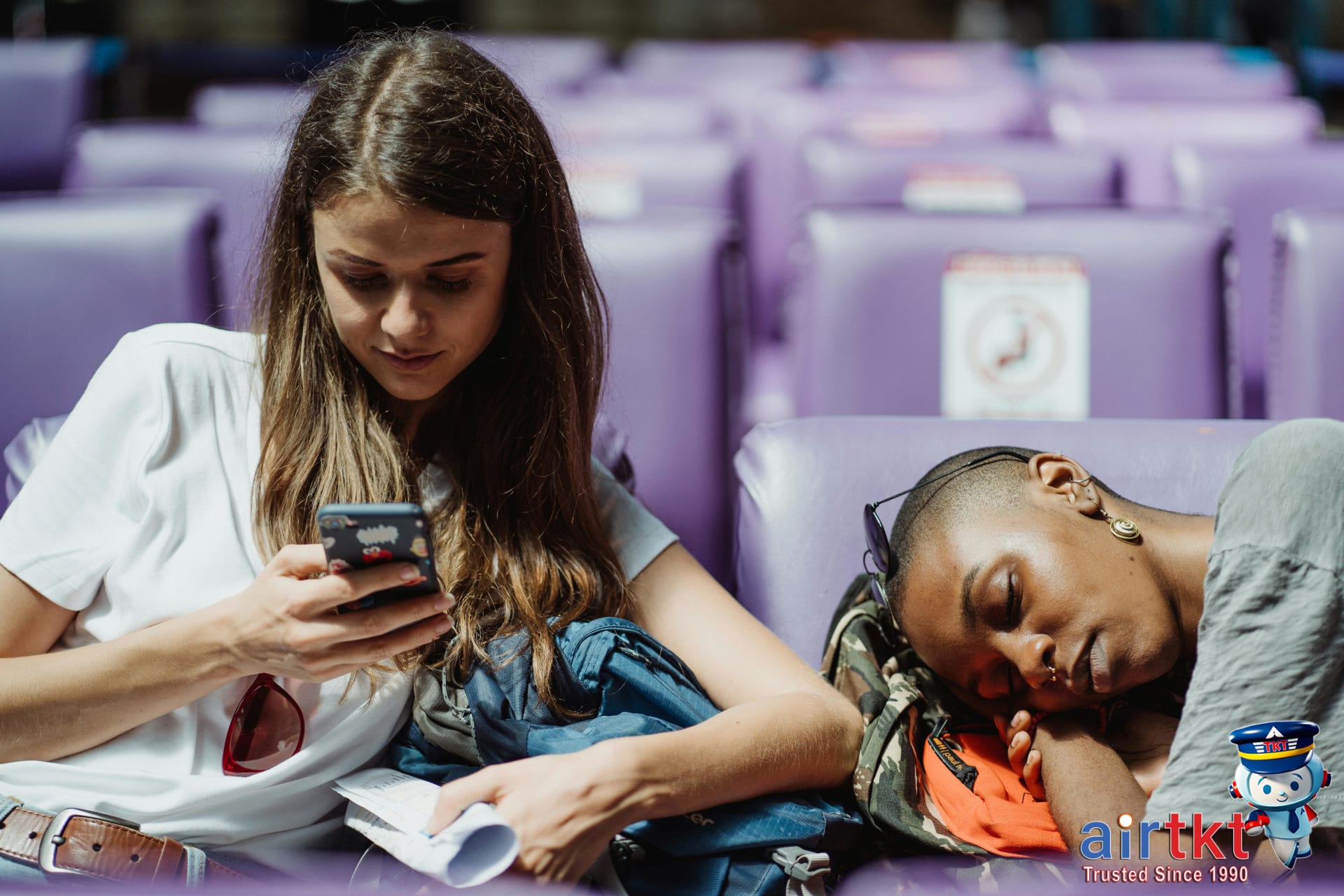 Two young women relaxing in a quiet station area