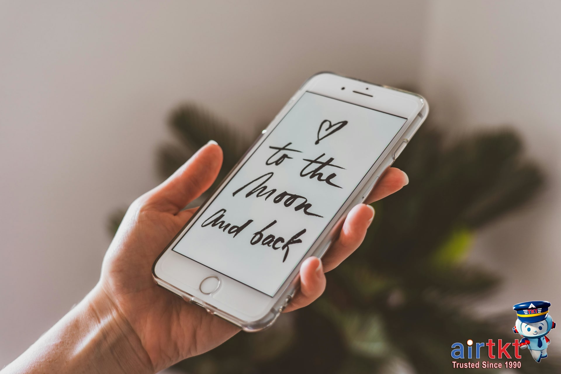 Hand holding smartphone displaying a travel booking app