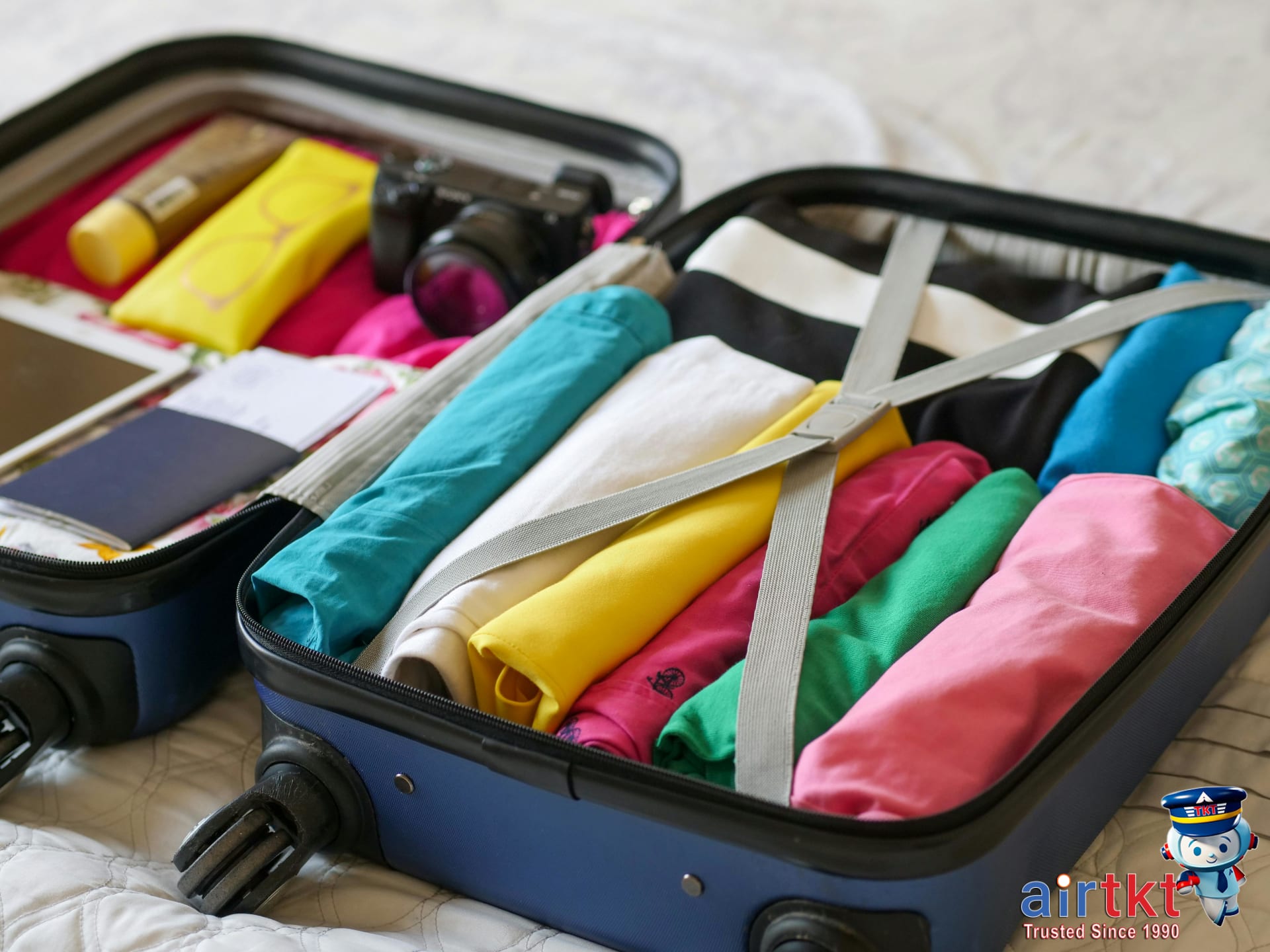 Traveler packing light luggage using packing cubes