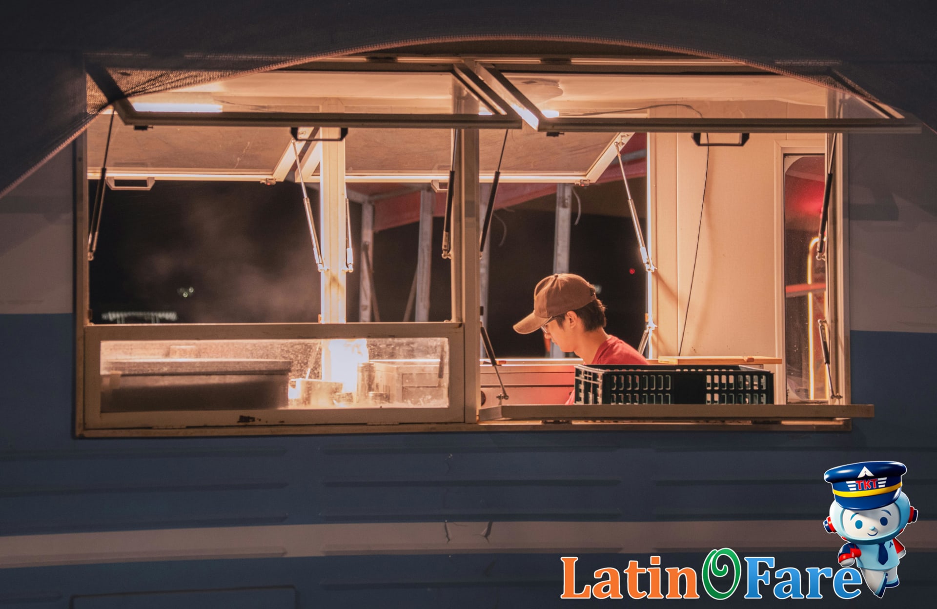 Nighttime food truck with worker serving customers