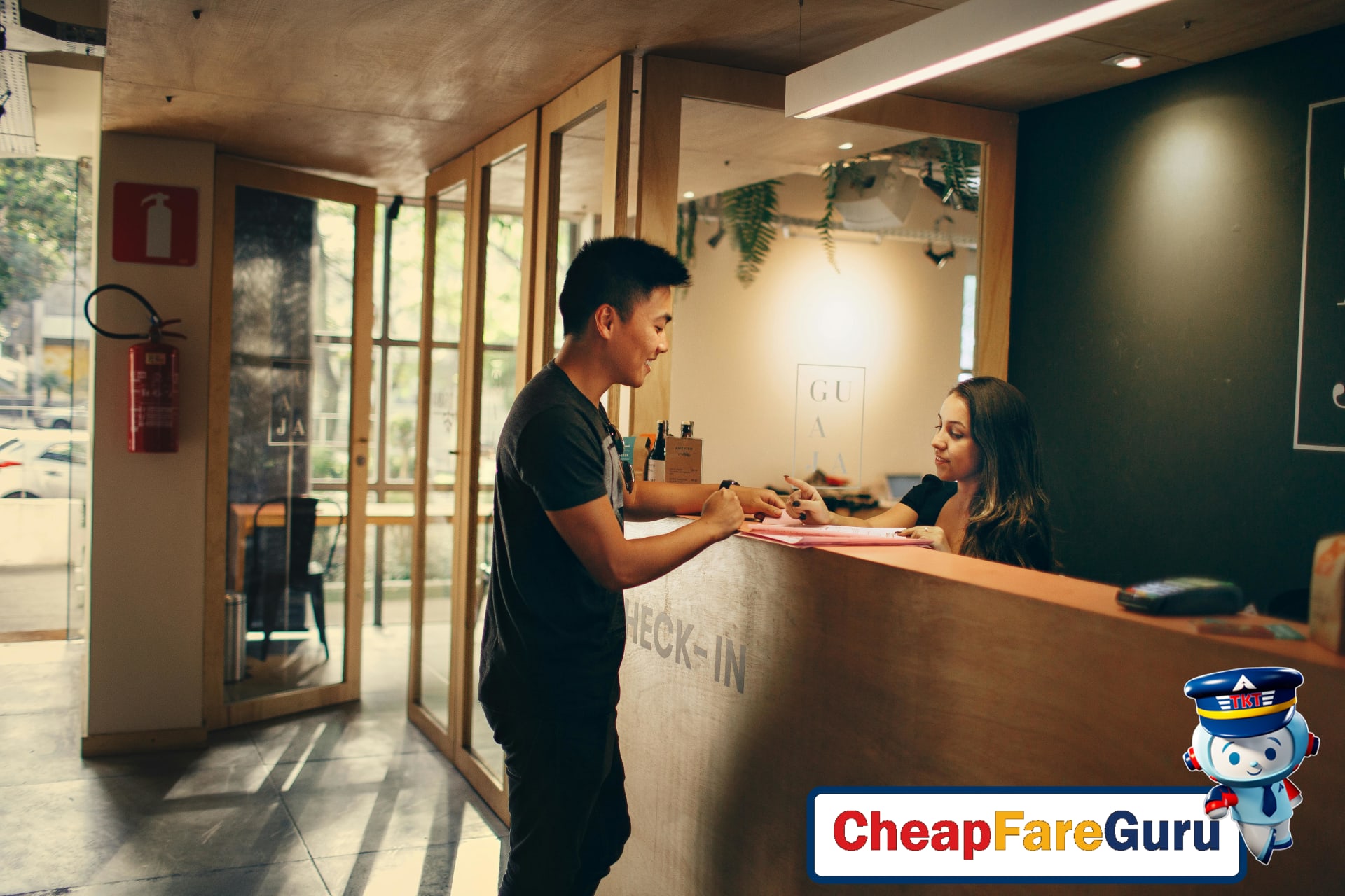 Traveler checking in at hotel reception desk