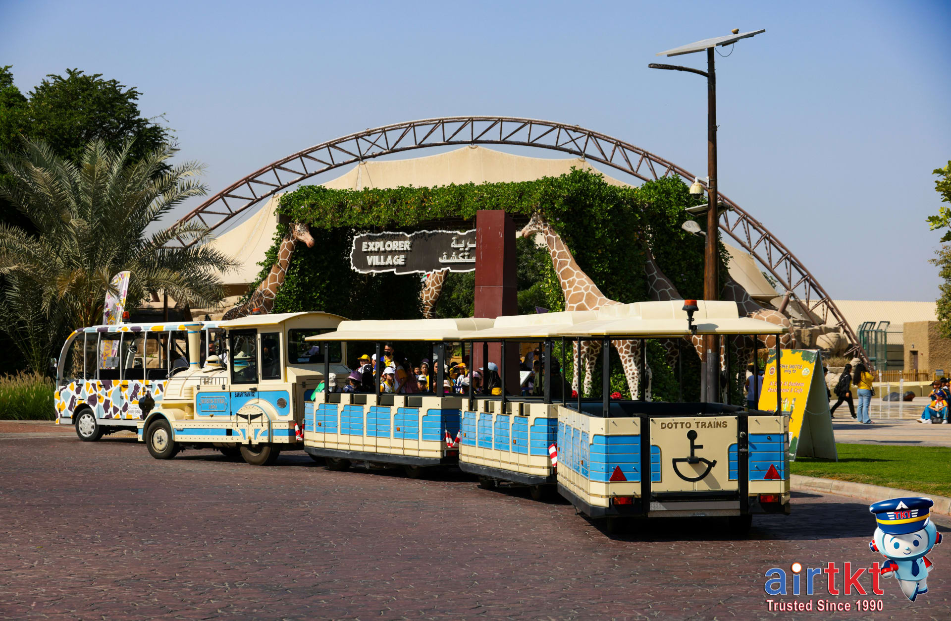 Family playing on tropical beach sand with palm trees