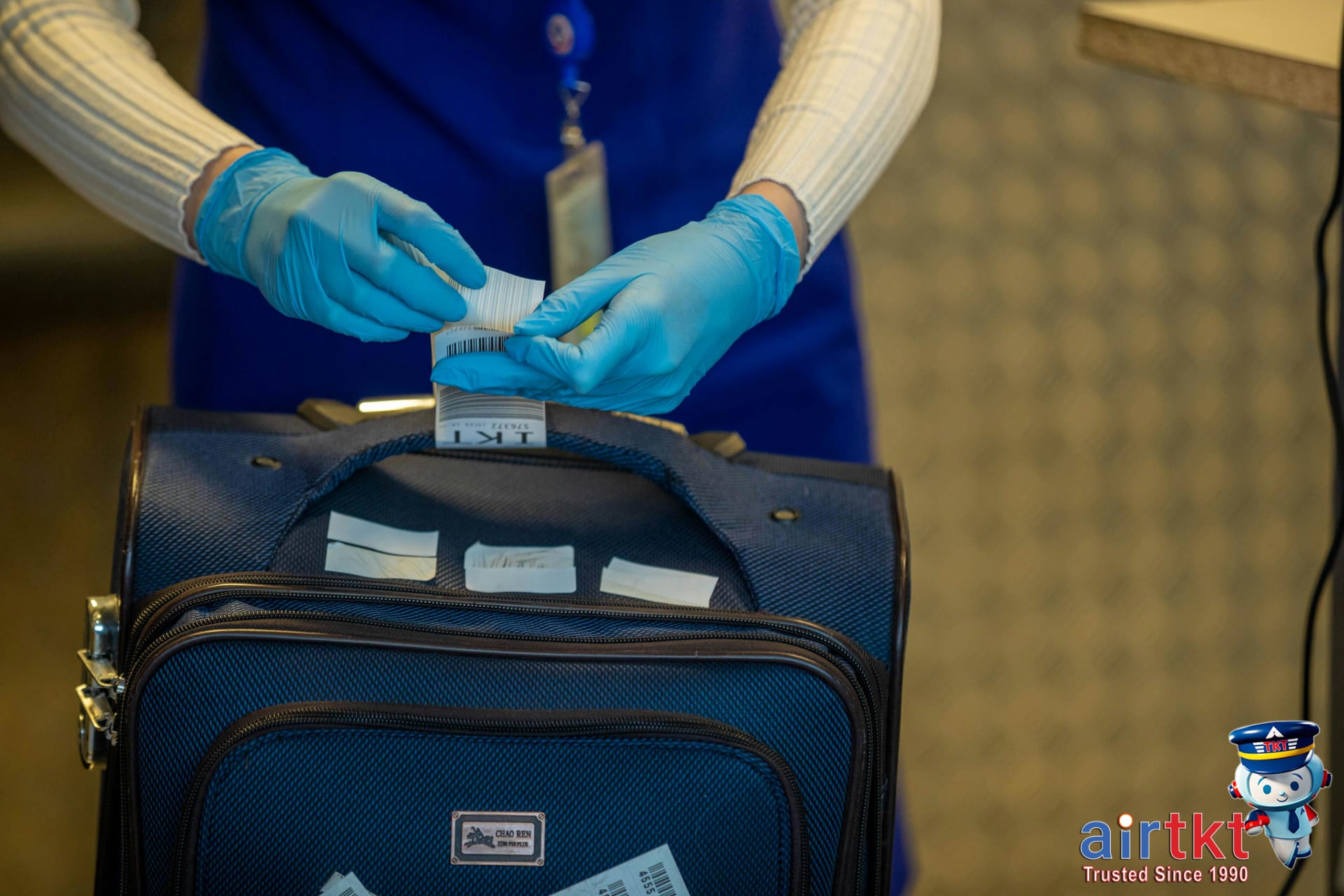 Passenger going through TSA security checkpoint with luggage