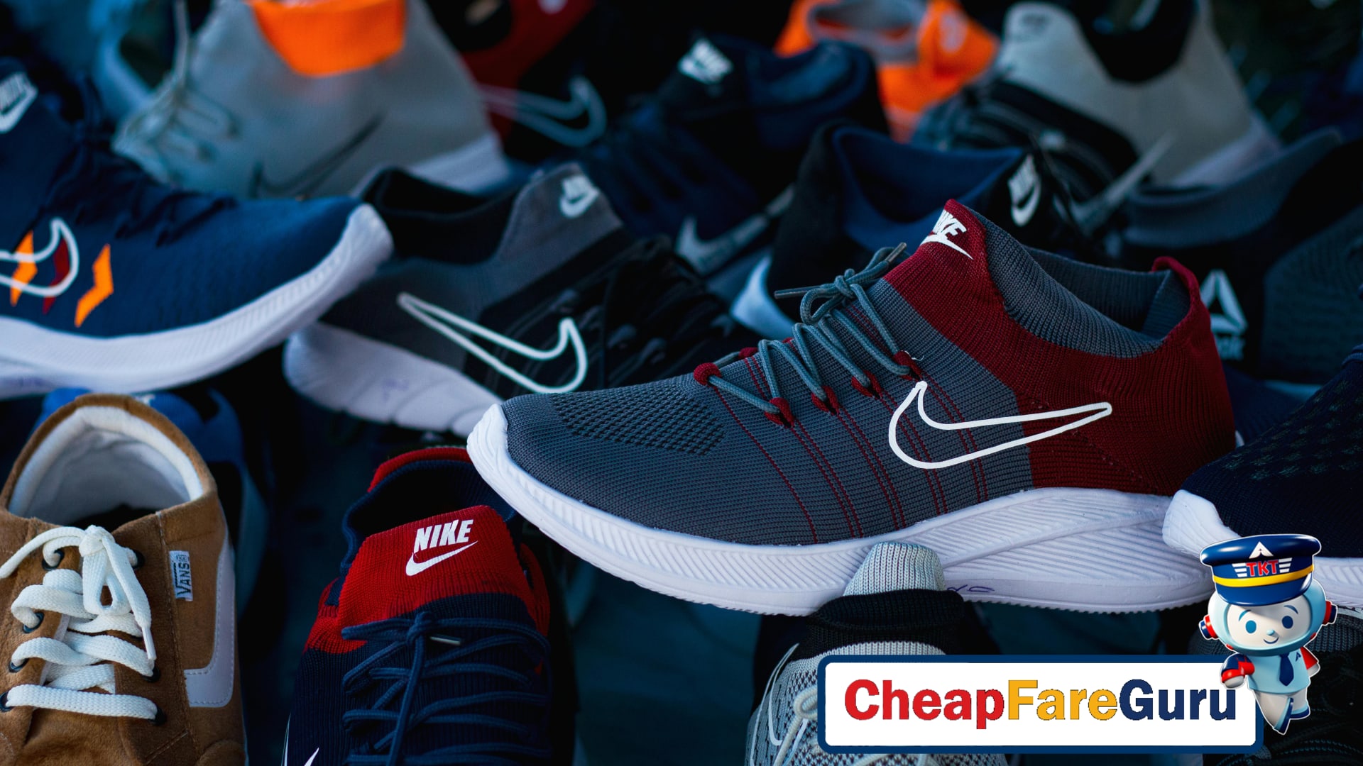 Different types of travel shoes on wooden floor