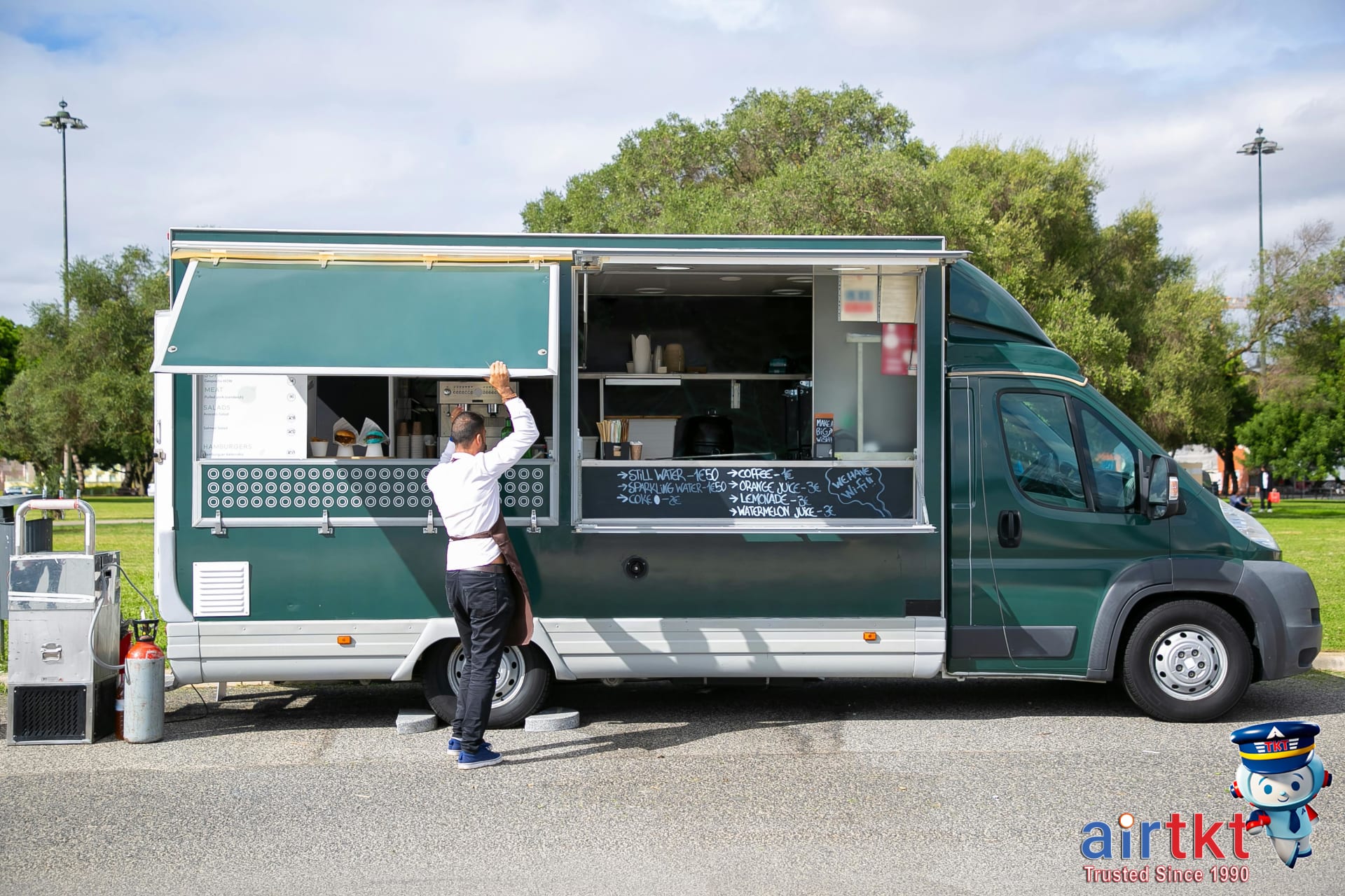 Street vendor opening food truck window preparing local cuisine