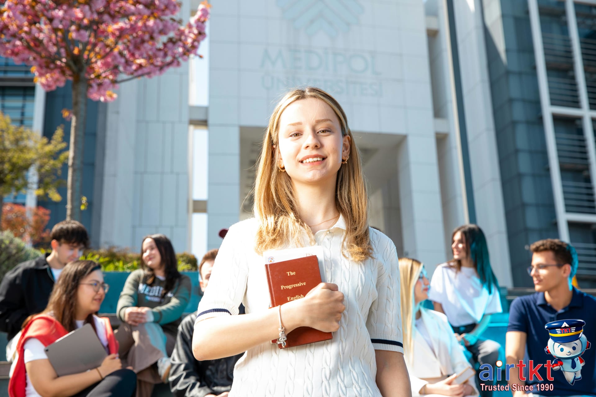 Happy university students socializing on campus on a sunny day in Syracuse