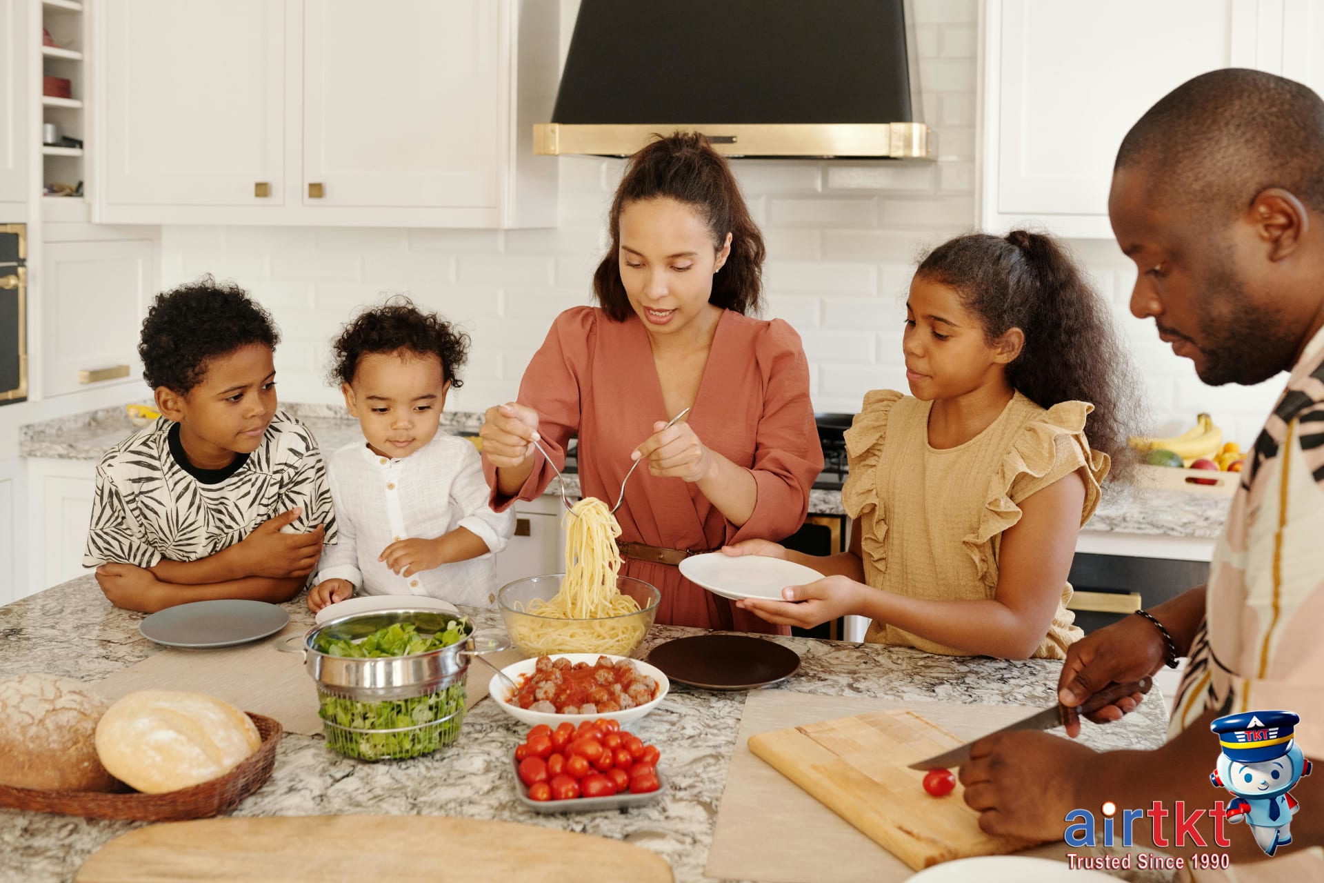 Family enjoying a meal in a kitchen-equipped accommodation