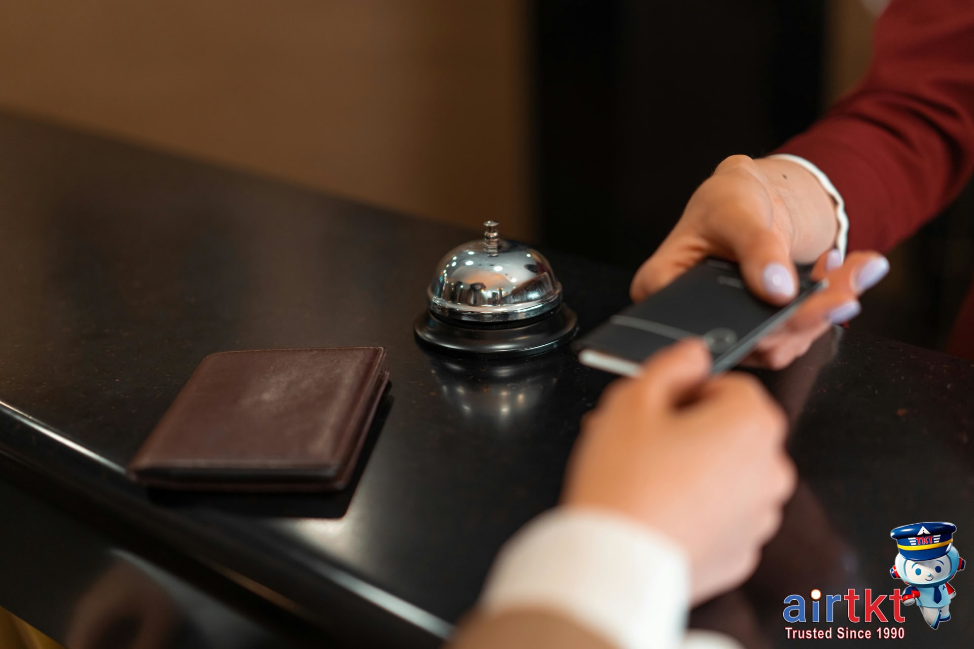 Traveler using credit card and mobile app for hotel booking