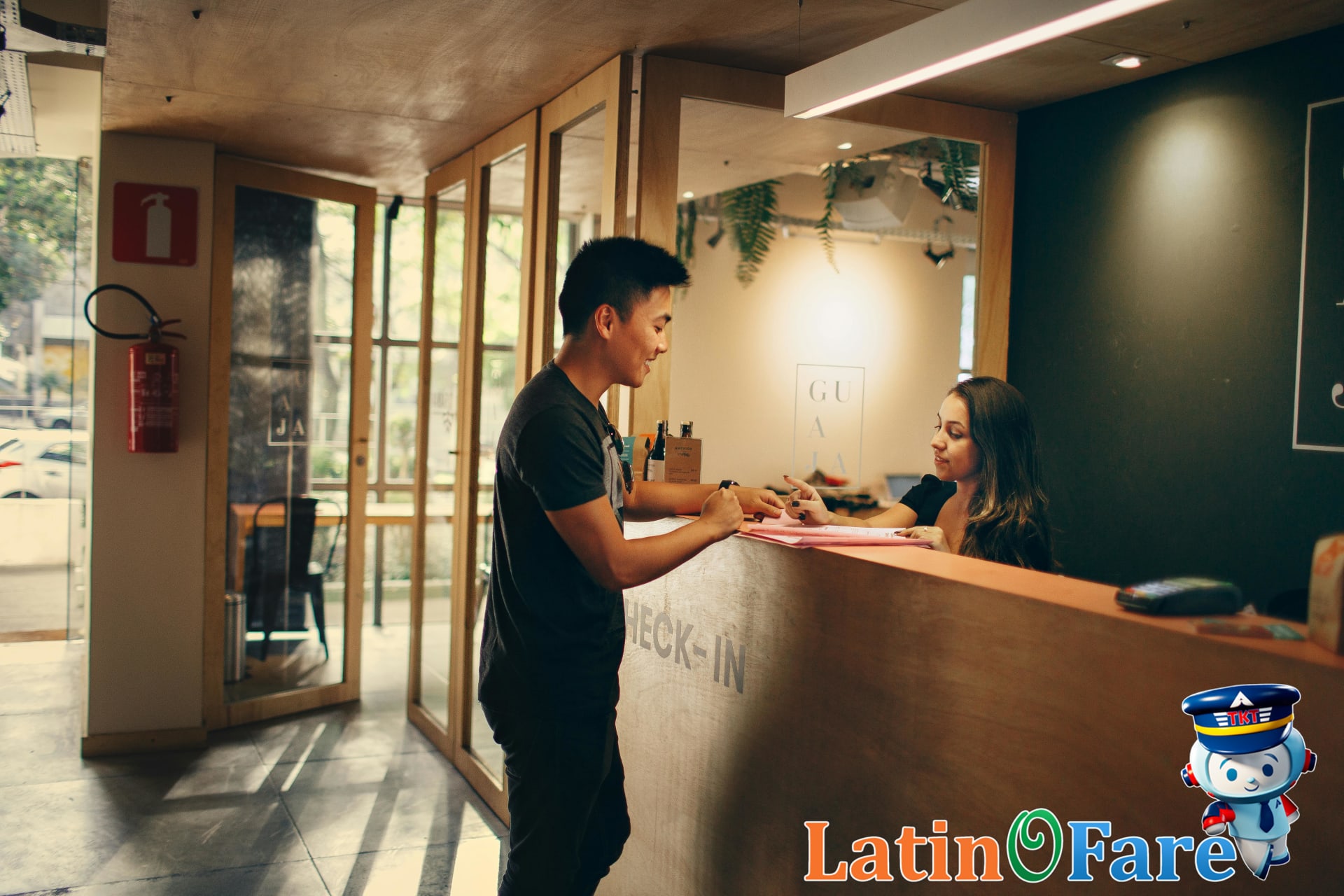 Traveler checking in at hotel front desk