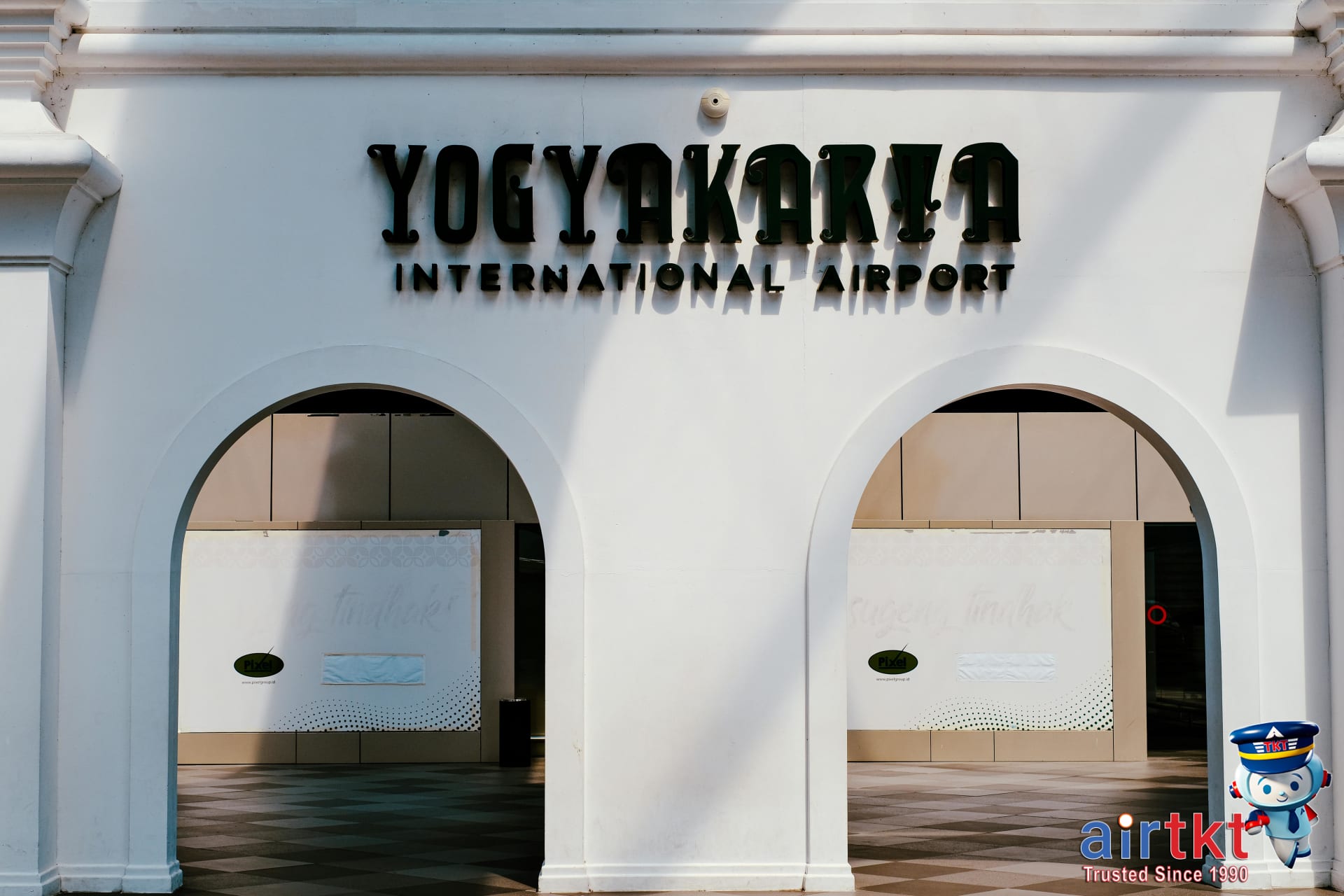 Entrance of Brussels airport terminal with transit signs