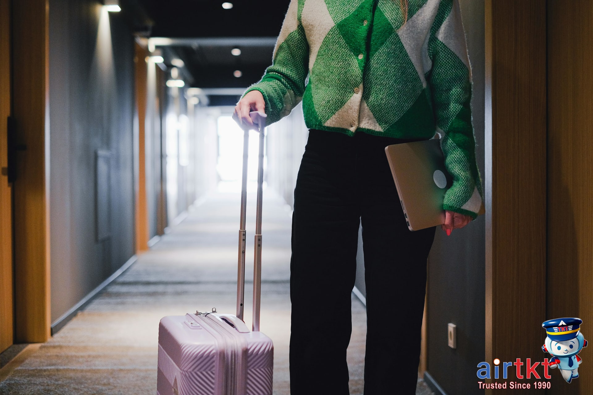 Traveler checking prices and booking accommodations using laptop.