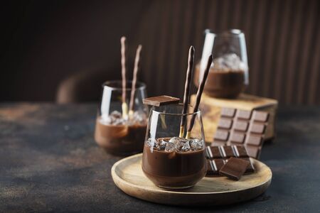 Creamy sweet liqueur with chocolate and ice, selective focus Stock Photo