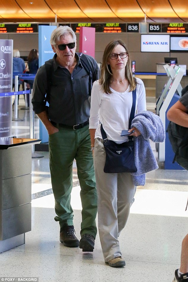 On their way: Supergirl actress Calista looked relaxed in a long-sleeved white T-shirt and cream trousers