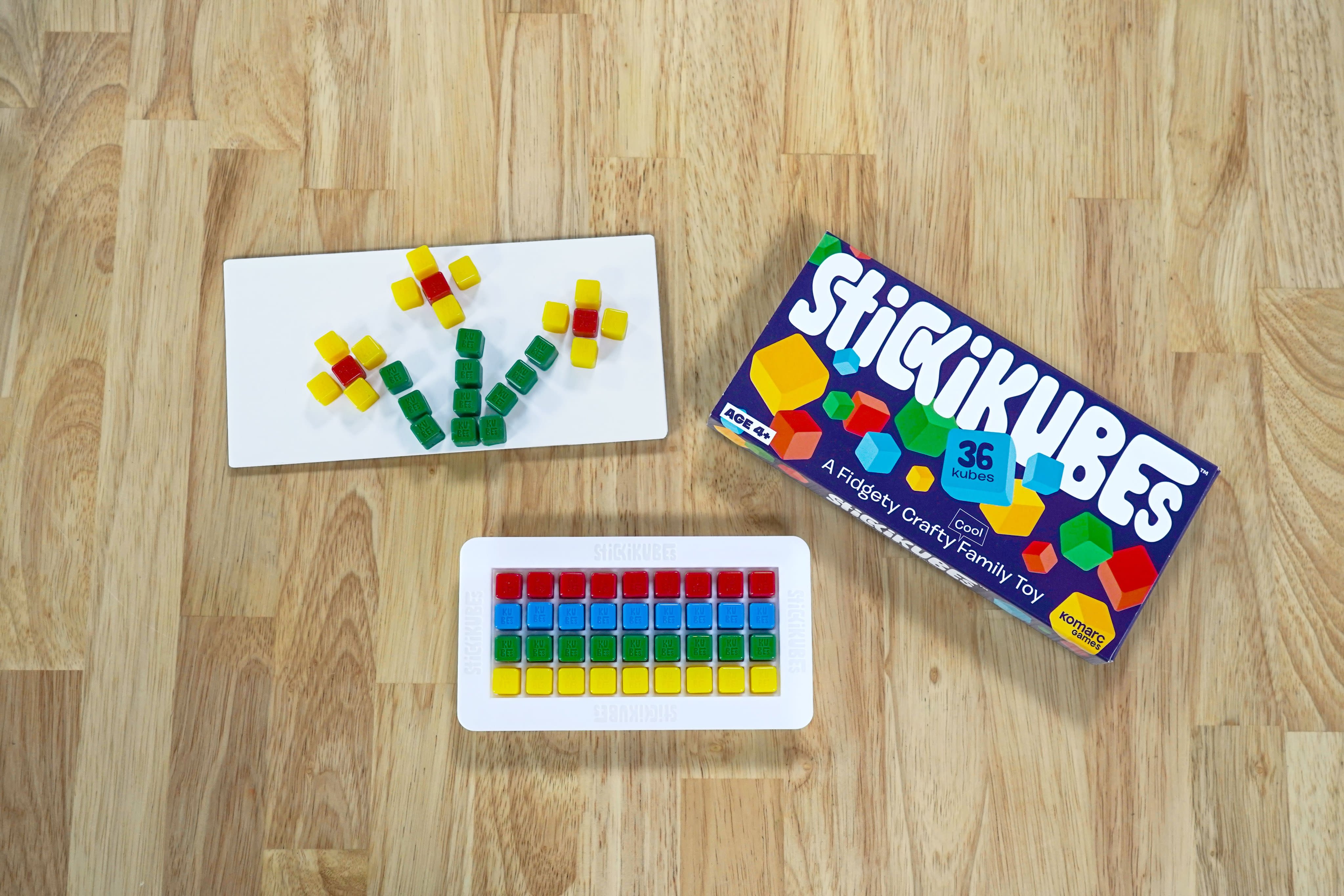 KOMARC GAMES StickiKubes - Mini Stacking Cubes That Stick to Anything - 125  Cubes in 4 Colors - Plastic Tub - Non Toxic Kid Safe