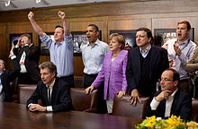 Prime Minister David Cameron of the United Kingdom, President Barack Obama, Chancellor Angela Merkel of Germany, Jose Manuel Barroso, President of the European Commission, President Francois Hollande of France and others react emotionally while watching the overtime shootout of the Chelsea vs. Bayern Munich Champions League final, in the Laurel Cabin conference room during the G8 Summit at Camp David, Maryland, May 19, 2012. Cameron raises his arms triumphantly as the Chelsea team wins their first Champions League title in the overtime shootout.