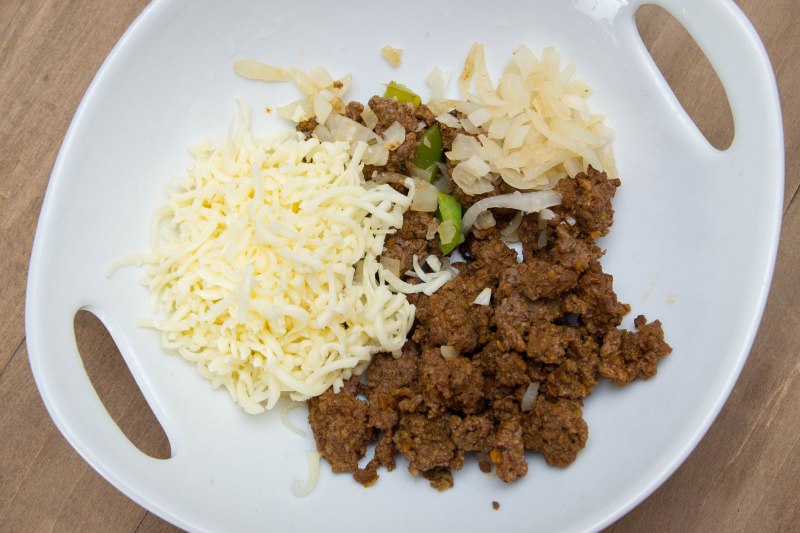Taco seasoned ground beef, bell peppers, onions, Monterrey jack cheese