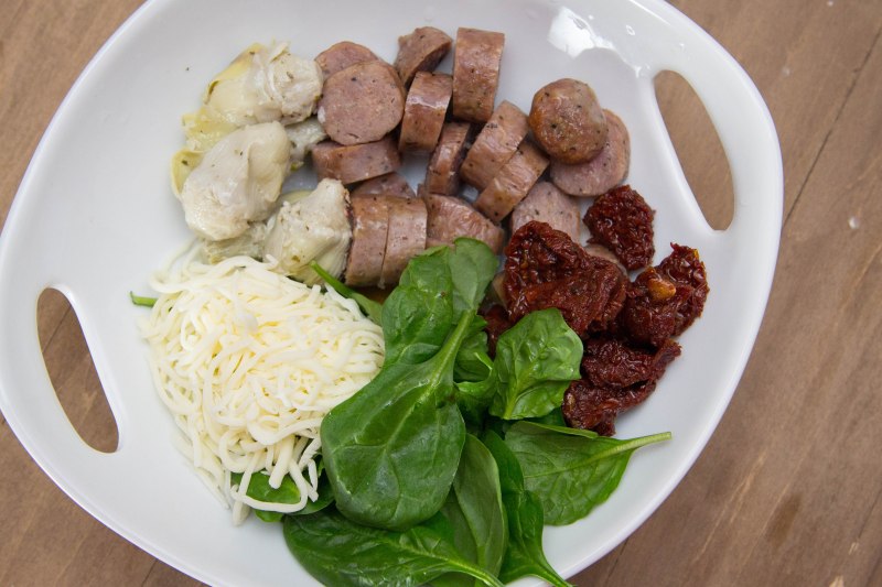 Sun-dried tomatoes, spinach, sweet Italian sausage, artichoke hearts, Mozzarella, pesto