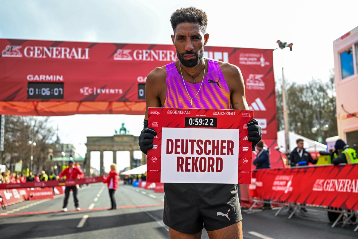 ** Amanal Petros running through Berlin streets during his record-breaking half marathon performance