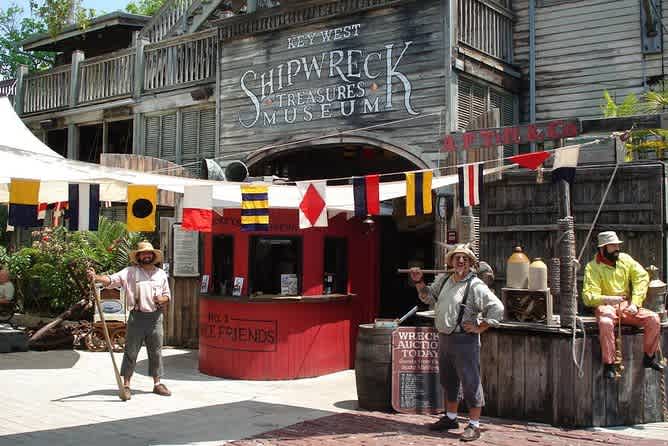 Tourists outside Key West Shipwreck Treasures Museum under sunny skies.