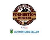 Logo of the American Prohibition Museum featuring a circular emblem with decorative text, flanked by stars on both sides. An eagle is perched atop the emblem, which is bordered in red and yellow. Below is a green lock symbol with text indicating an 'Authorized Seller.' The background is white.