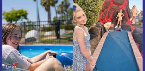 Two sections of a water park on a sunny day. On the left, a person with glasses smiles while sitting on a blue water slide tube next to a pool. On the right, another person stands at the end of a slide with hands on hips, looking at a person sliding down. Greenery and rocks are visible.