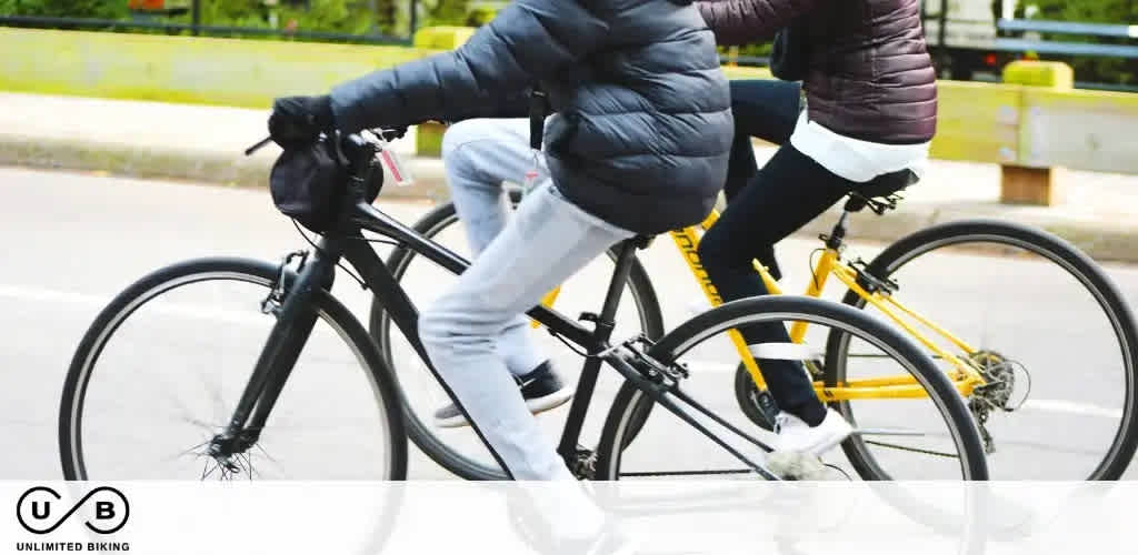 Image Description: Two individuals are cycling alongside each other on a road. The focus is on the lower half of their bodies, showcasing their legs in motion while they ride bikes. The person on the left is riding a black bicycle, while the person on the right is on a bike with a black frame and distinctive yellow accents. They are both dressed in jackets and pants suitable for cool weather, and they appear to be actively pedaling. The bicycles feature thin tires, suggesting they are designed for street or urban cycling. In the foreground, we can see the logo "UB" with the text "UNLIMITED BIKING" beneath it, indicating a cycling-related activity or brand.

Final Sentence: At FunEx.com, we're committed to offering exclusive discounts, ensuring you enjoy the lowest prices on tickets for a variety of memorable experiences.