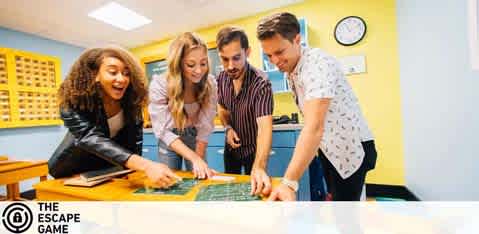 This image features four people engaged in a collaborative activity at The Escape Game. They are standing around a table in a brightly lit room with yellow walls and lockers in the background, which suggests the theme of the room may be related to a school or similar setting. Two women and two men appear to be examining and discussing a large, complex map or puzzle laid out on the table before them. They all show expressions of concentration and enjoyment, indicative of the immersive experience escape rooms provide. The photo captures a moment of teamwork and problem-solving.

For those interested in a thrilling group challenge, visit FunEx.com where you'll find tickets to exciting experiences like The Escape Game at the lowest prices, ensuring that you not only unlock the mysteries but also tremendous savings!