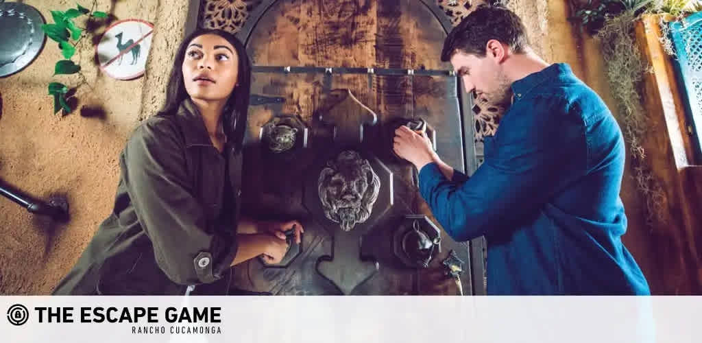 Image Description: Two individuals are engaged in an immersive experience at The Escape Game in Rancho Cucamonga. The environment seems to be themed with an adventurous, rustic decor. On the left, a woman is pictured intently analyzing a clue. She has dark hair, is wearing a green shirt, and appears focused on a task in front of her. On the right, a man is also examining part of the room for clues or puzzles to solve. He is wearing a dark blue shirt and is interacting with an object on the wall. The room is adorned with plants, and both participants show signs of concentration as they work towards their goal of solving the escape room challenge.

For enthusiasts ready to test their puzzle-solving skills, FunEx.com offers amazing discounts on tickets for experiences like The Escape Game, ensuring that you get the thrill of adventure at the lowest prices.