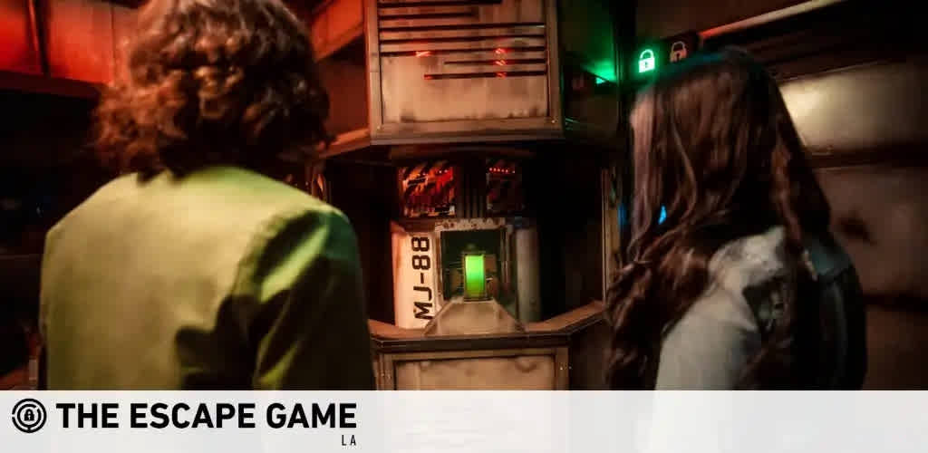 Image Description: The photo depicts two individuals engaged in an escape room activity at 'The Escape Game' in Los Angeles. The environment has a futuristic theme with dim, ambient lighting that creates an immersive experience. The person on the left is wearing a green jacket and is facing towards a wall with various panels and gadgetry suggestive of a control room setting. The individual on the right, whose back is to the camera, has long, brown hair and appears to be intently observing the surroundings. The walls are adorned with red and green lit buttons and screens, adding to the intricate design of the escape room. In the background, a green exit sign is visible, illuminating the path to the doorway. FunEx.com offers exclusive savings on tickets to the most engaging escape room experiences at the lowest prices guaranteed.