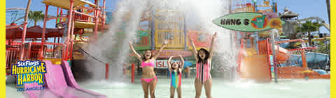 Image description: This is a vibrant panoramic image of a water park on a bright, sunny day. The central focus is on four individuals standing in a shallow pool with their arms raised in joy. They appear to be celebrating or expressing excitement under a cascade of water from a large bucket tipping overhead. Behind them, the water park boasts colorful structures, including water slides in pink and yellow hues, and a large sign that reads "Hang 5". The surroundings suggest an atmosphere of fun and lively entertainment as guests enjoy water activities. In the background, other water park amenities and guests are visible, enhancing the sense of a bustling, enjoyable summer outing.

Experience unforgettable summer fun and make a splash while enjoying savings on your adventure — visit FunEx.com for the lowest prices on tickets.