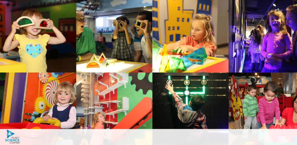 This image is a colorful collage showing six different scenes with children engaged in interactive play and learning activities at a science center, each capturing a moment of discovery and exploration that appeals to children's natural curiosity.

In the upper-left photo, a young girl with blond hair is smiling widely, her eyes covered by an oversized pair of colorful binoculars which are part of an exhibit. She is wearing a yellow top with a heart emblem on the front.

Moving to the right, in the upper-middle picture, three children are using hand-held devices to view exhibits. They appear focused and curious about what they're seeing.

The upper-right photo features two excited girls, one with blond hair, the other with brown hair, both wearing 3D glasses in a dark room lit by vibrant purple light as they interact with an exhibit that seems to captivate them.

In the bottom row, the leftmost photo captures a young blond girl sitting at a table, her attention on toy building blocks in front of her, a look of concentration on her face.

The center image on the bottom row shows a boy reaching upwards towards interactive lights on a wall. His arm is extended as he touches one of the illuminated circles.

Lastly, on the bottom right, two toddlers, one wearing a red striped shirt and the other in pink, are walking alongside a wooden station, both looking intently at a colorful, hands-on exhibit.

Each moment within these images reflects the fun, educational experiences available for children at the science center,