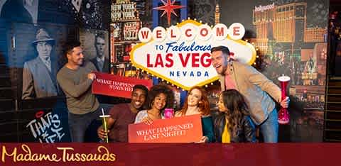 This image captures a lively group of people at the entrance of Madame Tussauds in fabulous Las Vegas, Nevada. The welcoming red backdrop is emblazoned with bold, white capital letters inviting visitors to the renowned attraction. A mix of men and women are seen smiling and engaging with one another, conveying a sense of excitement and fun. In their hands are souvenir cups and a guide brochure, suggesting they are tourists about to embark on an entertaining journey through the wax museum. The atmosphere is casual and happy, with a touch of Vegas flair indicated by the city skyline and bright lights in the background.

Unlock the best experience at Madame Tussauds with FunEx.com, where you can find the lowest prices and greatest savings on tickets for your next adventure.