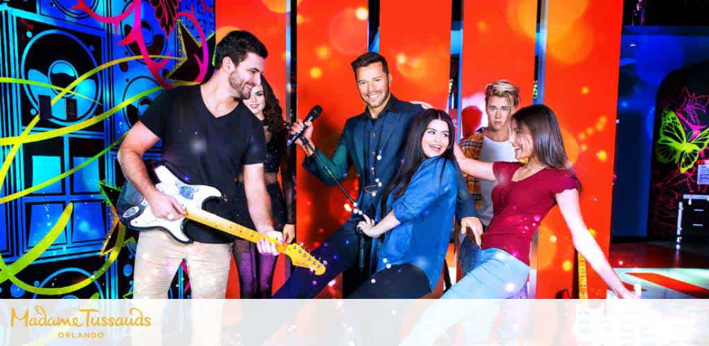 Visitors posing with wax figures at Madame Tussauds Orlando, vibrant backdrop.