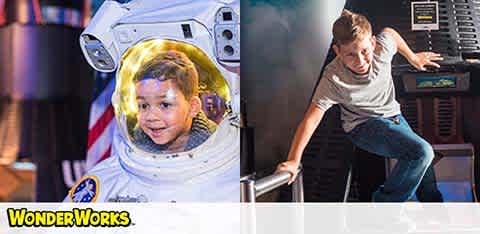 Two boys at an interactive exhibit: one wearing a spacesuit, another engaging with a simulator.