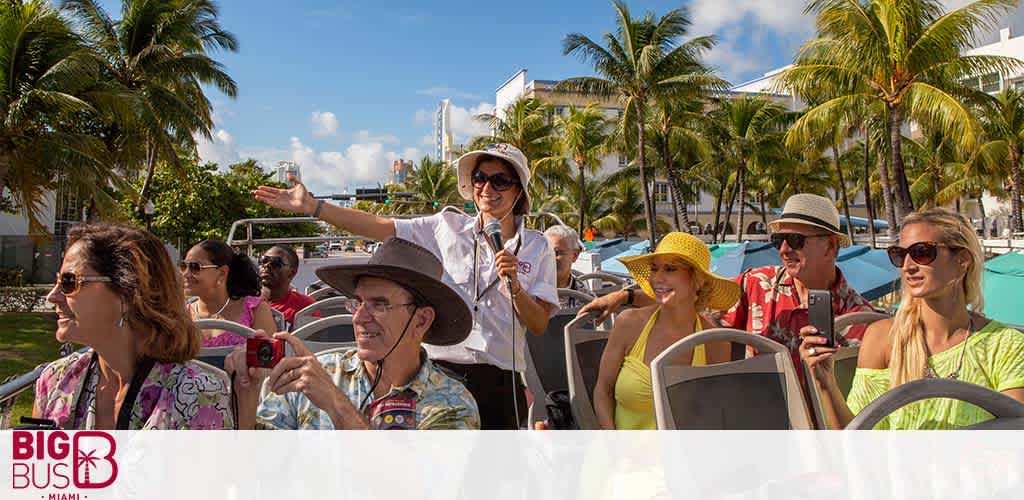 Tourists enjoy a sunny open-top bus tour with a guide pointing out sights.