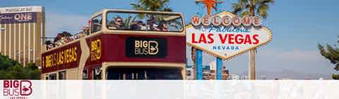 Image shows a red double-decker tour bus labeled 'BIG BUS' on the side, with passengers seated on the open top deck. In the background, the iconic 'Welcome to Fabulous Las Vegas Nevada' sign is prominently displayed against a clear blue sky.