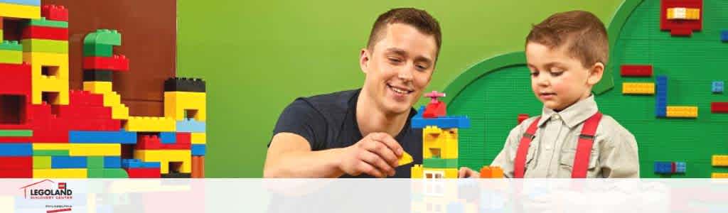 Banner shows a smiling adult and child playing with colorful LEGO blocks on a table in front of a backdrop with LEGO patterns. The Legoland logo is visible in the corner.
