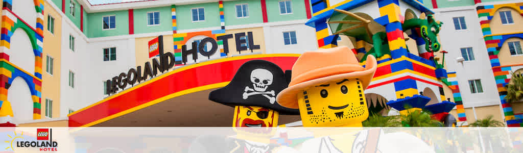 This image features the vibrant facade of the LEGOLAND Hotel. The hotel appears brightly colored with a theme consistent with LEGO, showcasing block-like patterns on its exterior. Prominently displayed is the hotel's name in large, bold letters above the entrance. To the right, there's a playful oversized LEGO figure wearing a cowboy hat, with a friendly smile and a scarf around its neck. The figure stands adjacent to another LEGO character dressed as a pirate with a black hat and eye-patch. A LEGO dragon sculpture protrudes from the hotel's sidewall, adding to the whimsical atmosphere. The hotel façade is designed to excite visitors of all ages with its playful characters and colorful LEGO theme.

At FunEx.com, experience the joy of savings while treating your family to an epic adventure with our lowest prices on tickets to fun destinations.