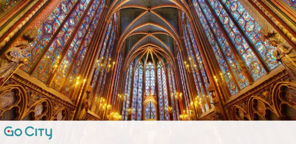 Interior view of a Gothic cathedral with stunning stained glass windows covering the walls and ceiling. The intricate designs feature vibrant colors, casting a warm glow across the space. Tall columns and arches line the sides, adorned with detailed carvings. Chandeliers hang elegantly, illuminating the architecture. A beautiful display of medieval craftsmanship and artistry, offering a breathtaking atmosphere of history and reverence.