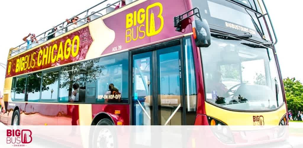 Image shows a vibrant red and yellow double-decker Big Bus with 'Big Bus Chicago' branding on its side. The upper deck is open, and a few passengers are visible enjoying the ride. The words 'Hop-on Hop-off' are also displayed, indicating the flexible tour service offered. The bus is parked, and the sky is clear. Big Bus logo is in the bottom right corner.
