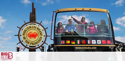 Tourists on a Big Bus sightseeing near Fisherman's Wharf signage in San Francisco.